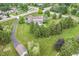 Expansive aerial view of a home with a pool, lush greenery, and a long, winding driveway at 10594 Geist Rd, Fishers, IN 46037