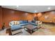Finished basement with blue sectional couch and decorative checkerboard table, perfect for lounging at 10594 Geist Rd, Fishers, IN 46037
