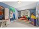 Fun bedroom design with a colorful daybed, playful art, and window with plantation shutters at 10594 Geist Rd, Fishers, IN 46037