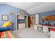 Bedroom with a playful design and an adjacent workspace, featuring blue walls and white carpeting at 10594 Geist Rd, Fishers, IN 46037