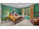 Cozy bedroom with green walls, a ceiling fan, a window, and decorative furniture and accents at 10594 Geist Rd, Fishers, IN 46037