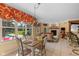 Bright dining area featuring a view of the pool, elegant chandelier, and access to the cozy living space at 10594 Geist Rd, Fishers, IN 46037