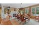Formal dining room with fireplace, built-in shelving, large windows with a pool view, and stylish decor at 10594 Geist Rd, Fishers, IN 46037