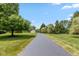 Long private driveway lined with mature trees leading to a home at 10594 Geist Rd, Fishers, IN 46037