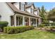 Charming two-story home with a red front door, manicured hedges and an American flag at 10594 Geist Rd, Fishers, IN 46037