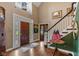 Elegant home foyer featuring hardwood floors, staircase, and ample natural light at 10594 Geist Rd, Fishers, IN 46037