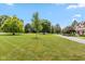 Expansive front lawn with mature trees and a private driveway leading to the house at 10594 Geist Rd, Fishers, IN 46037