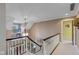 Hallway showcases a black and white railing and trim, adjacent to the staircase and a window at 10594 Geist Rd, Fishers, IN 46037