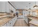 Spacious kitchen featuring white cabinets, granite countertops, stainless steel appliances, and ample counter space at 10594 Geist Rd, Fishers, IN 46037