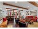 Open-concept living room with exposed beams, hardwood floors, and bar area at 10594 Geist Rd, Fishers, IN 46037