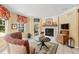 Inviting living room with a brick fireplace, comfortable seating, and view to the outdoor patio at 10594 Geist Rd, Fishers, IN 46037