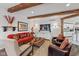 Cozy living room featuring exposed beams, shiplap walls, and stylish furnishings at 10594 Geist Rd, Fishers, IN 46037