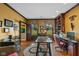 Well-appointed home office with built-in bookshelves, hardwood floors, and abundant natural light at 10594 Geist Rd, Fishers, IN 46037