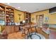 Well-lit home office featuring custom built-in shelving, a desk, and wood floors at 10594 Geist Rd, Fishers, IN 46037