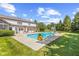 Sparkling in-ground pool surrounded by lush greenery, a patio, and a well-maintained lawn at 10594 Geist Rd, Fishers, IN 46037