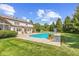 The backyard features an in-ground pool, a patio with lounge chairs, and lush landscaping at 10594 Geist Rd, Fishers, IN 46037