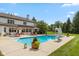 Beautiful in-ground pool area features a ladder and lounge chairs perfect for relaxation at 10594 Geist Rd, Fishers, IN 46037