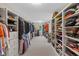 Large walk-in closet with rows of built-in shelving and storage, and plenty of room for clothes at 10594 Geist Rd, Fishers, IN 46037