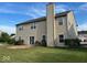 Well-maintained two-story home featuring a chimney, a sliding glass door and a green backyard at 11154 Schoolhouse Rd, Fishers, IN 46037