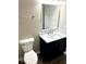 Bathroom with a modern vanity featuring a marble countertop and a sleek, square mirror at 11154 Schoolhouse Rd, Fishers, IN 46037
