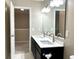Modern bathroom with dual sinks, elegant fixtures, and a view of the adjoining bedroom at 11154 Schoolhouse Rd, Fishers, IN 46037
