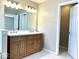 Bathroom featuring a wood vanity with double sinks and a white marble countertop at 11154 Schoolhouse Rd, Fishers, IN 46037