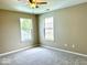 Bedroom with neutral paint, ceiling fan, carpet, and two large windows at 11154 Schoolhouse Rd, Fishers, IN 46037