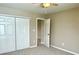 Bedroom with neutral paint, ceiling fan, carpet, and a double door closet with open doorway at 11154 Schoolhouse Rd, Fishers, IN 46037
