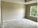 Bedroom with a large window and neutral-colored walls and ceiling fan at 11154 Schoolhouse Rd, Fishers, IN 46037