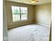 Neutral bedroom with a ceiling fan, carpet, and large window overlooking the front yard at 11154 Schoolhouse Rd, Fishers, IN 46037