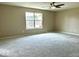 Bedroom with neutral walls, carpet, ceiling fan, and large window at 11154 Schoolhouse Rd, Fishers, IN 46037