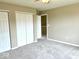 Bedroom with neutral walls, carpet, and a double door closet with open doorway at 11154 Schoolhouse Rd, Fishers, IN 46037