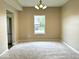 A spacious dining room with a window and modern light fixture and neutral walls at 11154 Schoolhouse Rd, Fishers, IN 46037