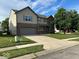 Two-story home featuring a brick and siding facade, an attached two-car garage, and a well-manicured lawn at 11154 Schoolhouse Rd, Fishers, IN 46037