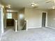 Upstairs hallway area featuring carpet and a view of a chandelier hanging near a window at 11154 Schoolhouse Rd, Fishers, IN 46037