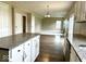 Open-concept layout with the kitchen island overlooking the living room, features granite counters and white cabinets at 11154 Schoolhouse Rd, Fishers, IN 46037
