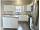 A bright kitchen with white cabinets, stainless steel appliances, and granite countertops at 11154 Schoolhouse Rd, Fishers, IN 46037