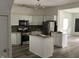Modern kitchen with stainless steel appliances, center island, and sleek white cabinetry at 1125 N Rural St, Indianapolis, IN 46201