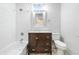 Bathroom features a vanity with storage, toilet, tub, and shower at 1151 S Randolph St, Indianapolis, IN 46203
