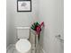 Toilet located in bathroom with decorative art and floral display adding a touch of elegance at 1151 S Randolph St, Indianapolis, IN 46203
