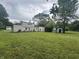 Rear exterior view of the home with a large backyard and mature trees at 1330 Schleicher Ave, Indianapolis, IN 46229