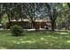 Spacious backyard with mature trees, patio, and ample room for recreation at 1346 N Buck Creek Rd, Greenfield, IN 46140