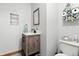 Charming bathroom with a single vanity, wooden cabinet, and decorative wall art adds character at 1346 N Buck Creek Rd, Greenfield, IN 46140