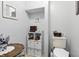 Neutral bathroom with white fixtures, decor, and ample storage shelves offers a clean aesthetic at 1346 N Buck Creek Rd, Greenfield, IN 46140