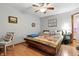 Comfortable bedroom featuring a ceiling fan, wood floors, and cozy furnishings at 1346 N Buck Creek Rd, Greenfield, IN 46140