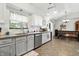 Updated kitchen with white cabinets, modern appliances, and a charming breakfast nook at 1346 N Buck Creek Rd, Greenfield, IN 46140