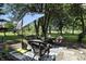 Relaxing outdoor patio area with wicker seating, umbrella, and views of the lush lawn at 1346 N Buck Creek Rd, Greenfield, IN 46140