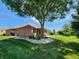 Backyard showcasing a well-maintained lawn and mature trees, offering a serene outdoor space at 1633 Belfield St, Indianapolis, IN 46217