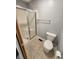 Updated bathroom with glass-enclosed shower, toilet, and towel rack at 1633 Belfield St, Indianapolis, IN 46217