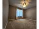 Comfortable bedroom featuring neutral walls, plush carpeting and a bright window with white trim at 1633 Belfield St, Indianapolis, IN 46217